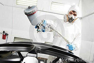 Auto mechanic painting car bumper Stock Photo