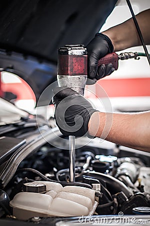 Auto mechanic repairer changing spark plugs on the car Stock Photo