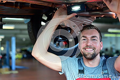 Auto mechanic repairs vehicle in a workshop Stock Photo