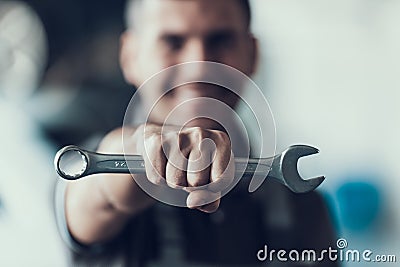 Auto Mechanic with Tool on Blurred Background Stock Photo