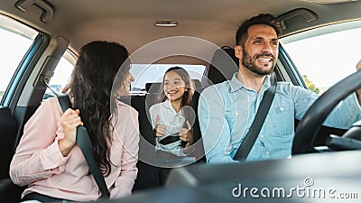 Auto purchase and rent. Happy caucasian family driving new automobile having test drive in city Stock Photo