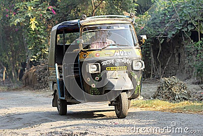 Auto rickshaw taxi on a road in Baidyapur, India Editorial Stock Photo