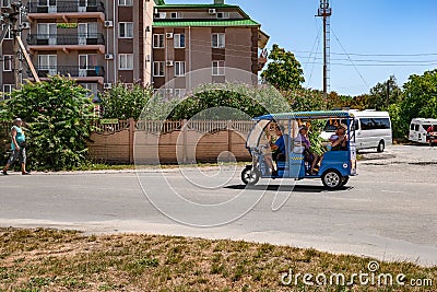 Auto rickshaw transports passengers on the street in Zalizny port Kherson region. Taxi in Editorial Stock Photo