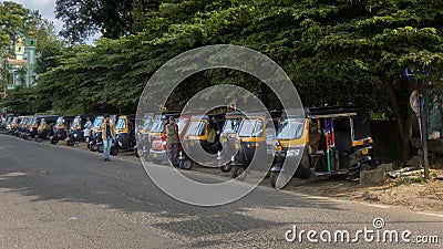 Auto rickshaws in a line on an Indian road Editorial Stock Photo