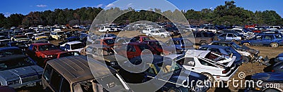 This is an auto salvage yard. The cars here are either crashed vehicles or no longer in use. They are wrecks all parked side by si Editorial Stock Photo