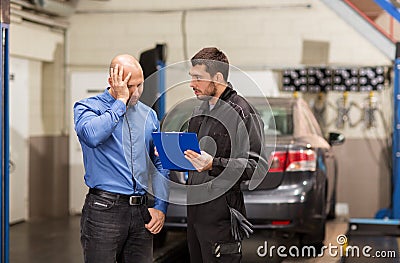 Auto mechanic and customer at car shop Stock Photo