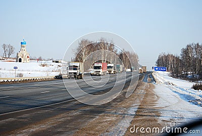 Auto trucks length gages go on Minskoye Highway in the winter clear morning. Editorial Stock Photo