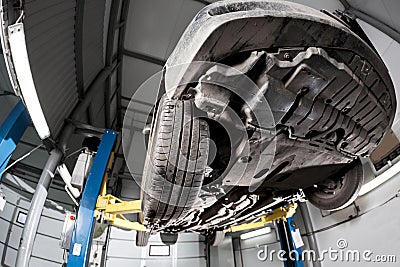 Auto view from the bottom. front car suspension. the garage mechanic raised the car on the lift Stock Photo