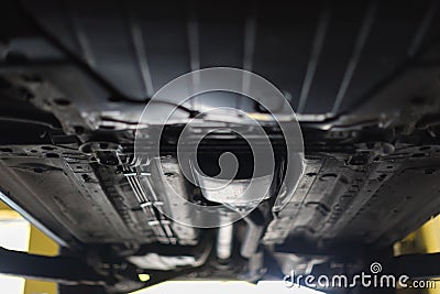 Auto view from the bottom. Garage mechanic raised the car on the lift. Stock Photo