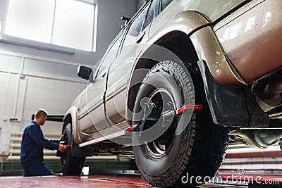 Auto wheel alignment in garage ,SUV maintenance Stock Photo