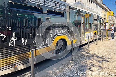 An autobus parked on its stop in Lisbon Editorial Stock Photo