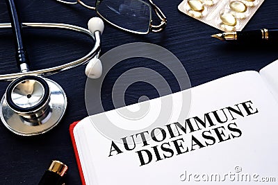 Autoimmune diseases. Book, pills and stethoscope on the desk. Stock Photo