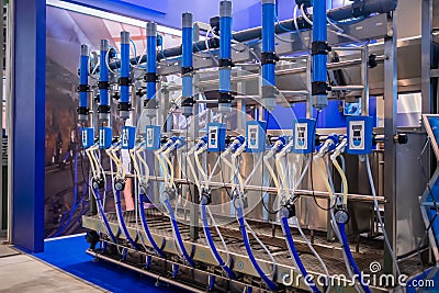 Automated goat milking suction machine with teat cups at exhibition Stock Photo