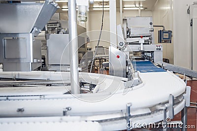 Industrial production cutting large quantities of meat.Automated line poultry equipment.Meat processing factory Stock Photo