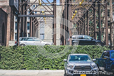 An automated multi-level outside parking system in Manhattan, New York City. Hedge surrounding the parking lot Editorial Stock Photo