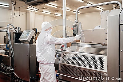 Automated production line with packaging and cutting of meat in modern food factory.Meat processing equipment. Stock Photo