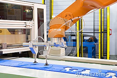 Automated robotic arm picking plastic forming sheet in industry Stock Photo