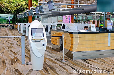 An automated self check-in kiosk next to the check-in counters at Changi Airport Terminal 3 Editorial Stock Photo