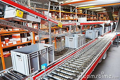 Automated warehouse. Boxes with spare parts moving on conveyer Stock Photo