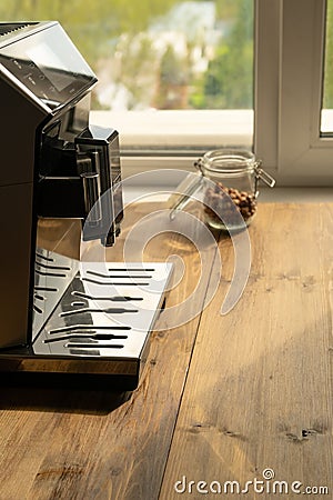 Automatic coffee machine for black coffee near window at daytime in a coffee shop, cafe or restaurant Stock Photo