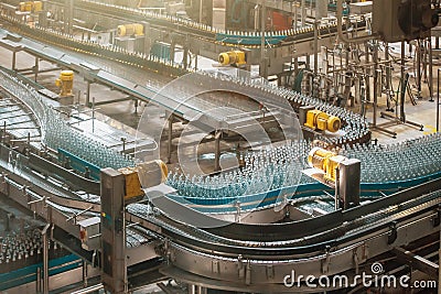 Automatic conveyor line or belt with glass bottles at brewery production. Industrial beer bottling equipment machinery Stock Photo