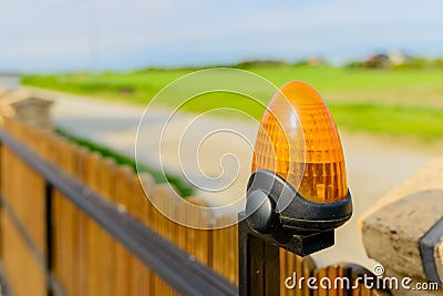 Automatic gate - wooden gate with warning lamp detail Stock Photo