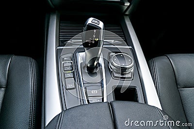 Automatic gear stick transmission of a modern car, multimedia and navigation control buttons. Car interior details. Transmission Stock Photo