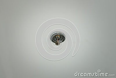 Automatic head fire sprinkler extinguisher on white ceiling light Stock Photo