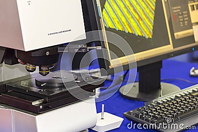 Automatic high technology and precision 3d measuring laser microscope with objective lenses and computer on table for industrial Stock Photo