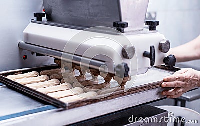 Automatic line for the production of eclairs. Eclair Cake Dough Baking, preparation Stock Photo