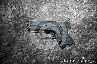 Automatic 9mm. handgun pistol on cement wall background Stock Photo