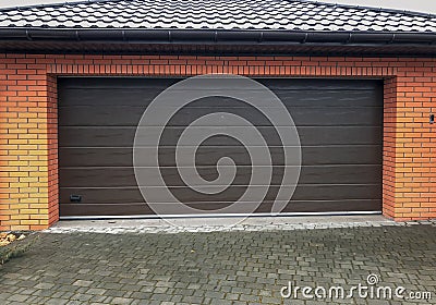Automatic opening and convenient garage door for a car garage. Stock Photo