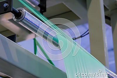 Automatic plastic bag making machine - roller with green polyethylene film Stock Photo