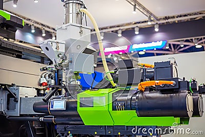 Automatic plastic injection molding machine during work at exhibition Stock Photo