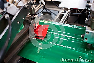 Automatic plastic pouches making and printing machine in modern factory, plastic packaging is mayor industrial manufacturing Stock Photo