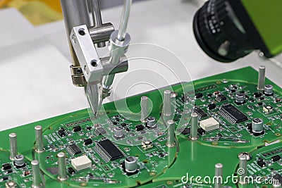 The automatic soldering robot operation with PCB board Stock Photo