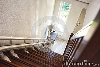 Automatic stairlift on staircase for elderly or disability in a house, Stock Photo