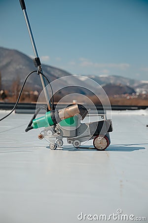 Automatic welder hot-air tools welds synthetic membranes on roof Stock Photo