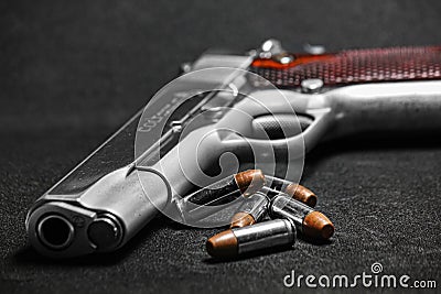 Automatic white gun stainless steel pistol weapon model m1911 with real bullet ammo head in black background Stock Photo