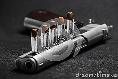 Automatic white gun stainless steel pistol weapon model m1911 with real bullet ammo head in black background Stock Photo