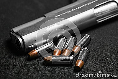 Automatic white gun stainless steel pistol weapon model m1911 with real bullet ammo head in black background Stock Photo