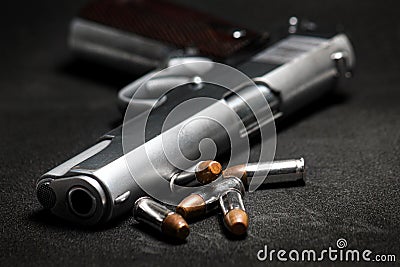 Automatic white gun stainless steel pistol weapon model m1911 with real bullet ammo head in black background Stock Photo