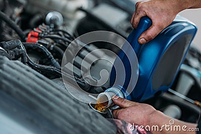Automechanic changing motor oil Stock Photo