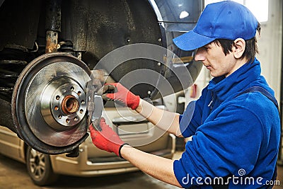 Automobile brake pads replacement in car repair shop or garage Stock Photo