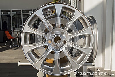 Automobile light-alloy wheels stand on a stand in the room Stock Photo