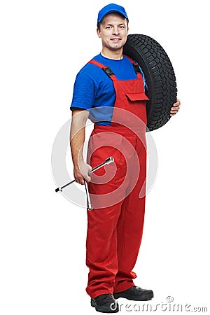 Automobile mechanic with car tire and spanner Stock Photo