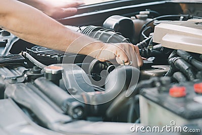 Automobile mechanic repairman hands repairing a car engine automotive workshop Stock Photo