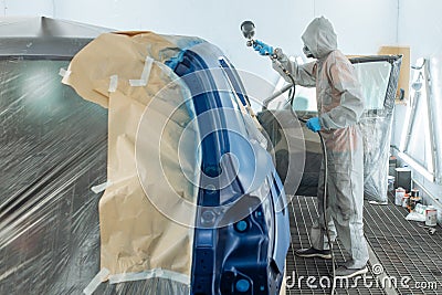 automobile repairman painter hand in protective glove with airbrush pulverizer Stock Photo