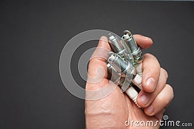 Automobile spark plugs in a man`s hand. Stock Photo