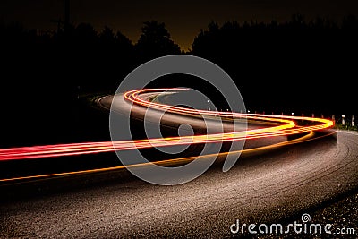 Automobile taillights on a dark country road Stock Photo